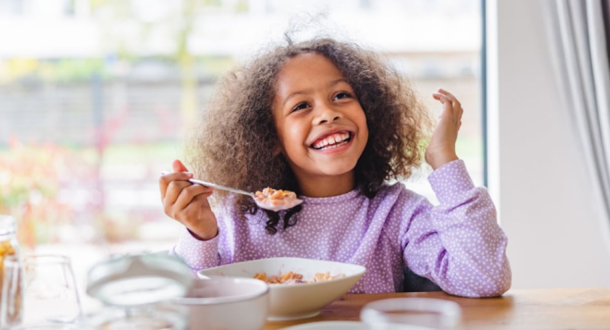 An image showing a child participating in packing their back-to-school lunch or a parent and child collaboratively selecting healthy foods, illustrating tips for managing picky eaters and encouraging them to explore new tastes.