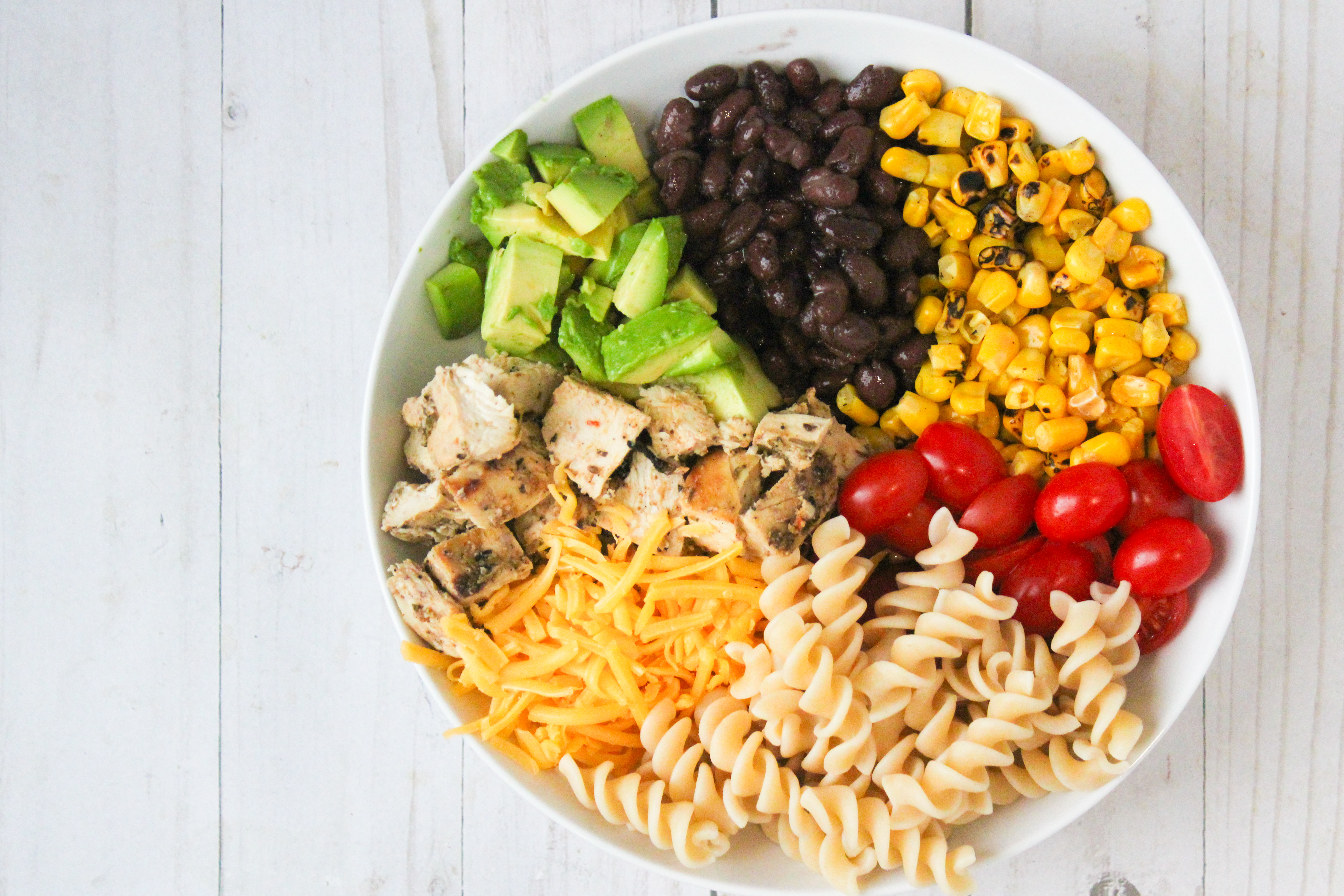 Simple Salad with chicken, pasta, corn, black beans, and cheese 